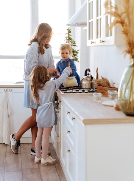 Mother with her kids cooking in the kitchen to xmas, casual lifestyle photo series in real life interior